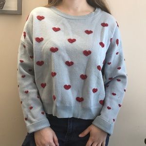 Blue sweater with red embroidered hearts